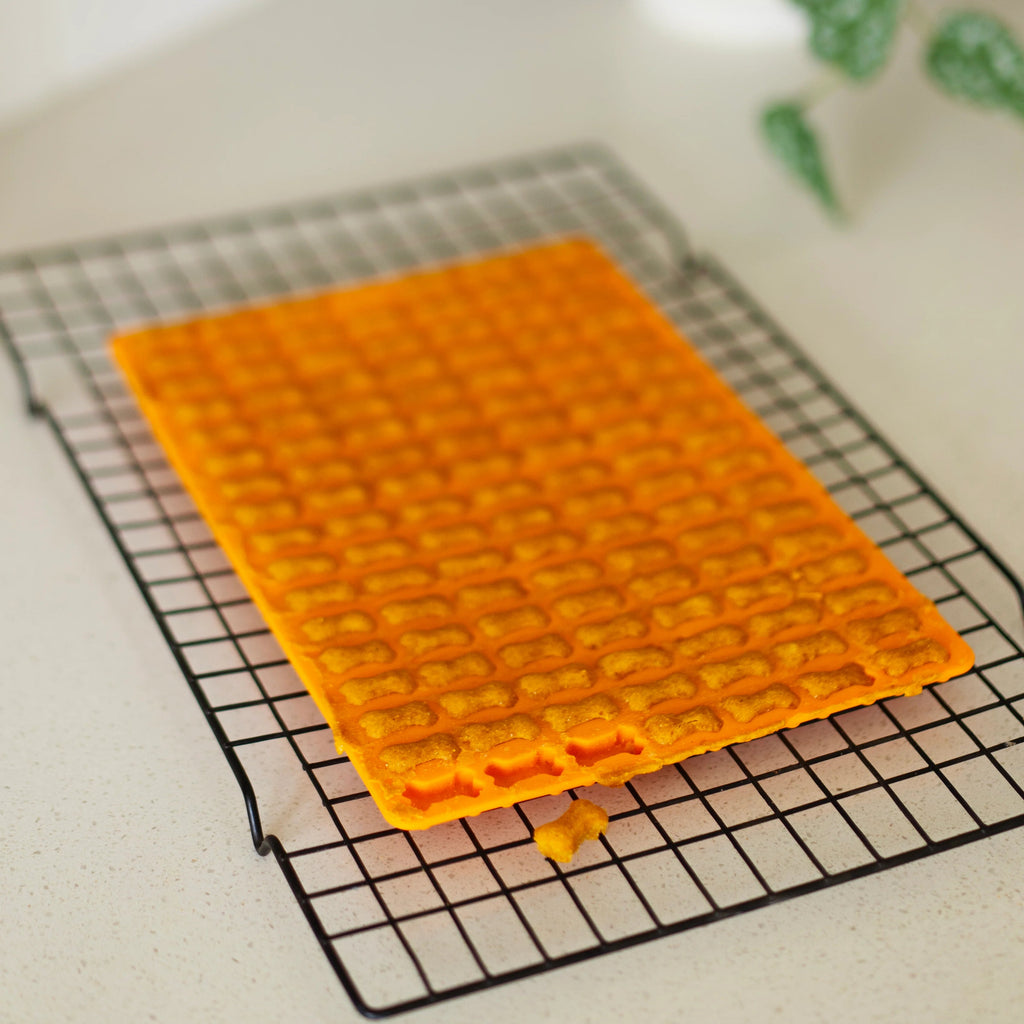 Orange silicone mold on a cooling rack. Dishwasher safe.