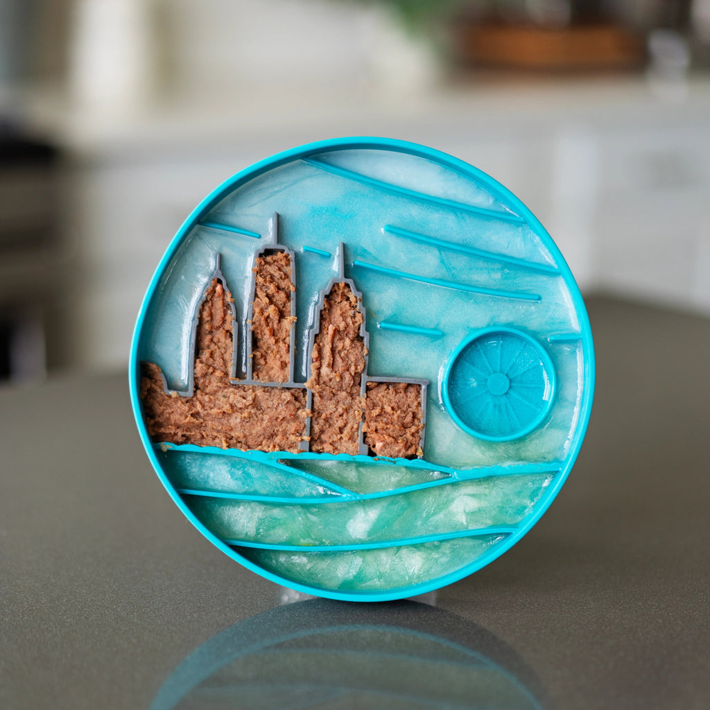 City skyline silicone dog bowl.  Food stuffed in the building to challenge the dogs. Frozen sky and water surrounding the city.
