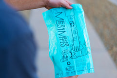 Unrolled and open blue dog poop bag.  Made from advanced Biorecyle plastic with over 50%  post consumer plastic