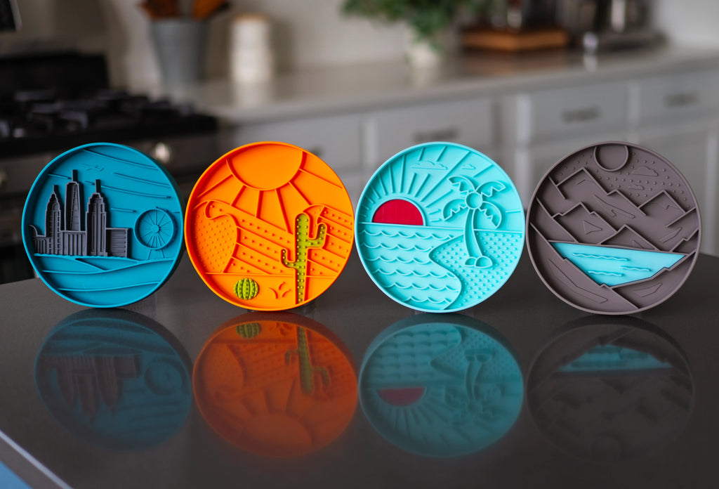 four new silicone low rise dog bowls with suction cups to hold in place on the floor.  landscape themes.
