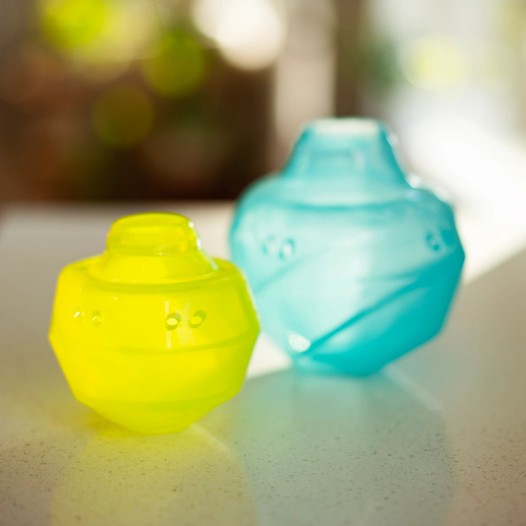 Green and Blue wobble ball for dog treats with the top popped up for easy cleaning