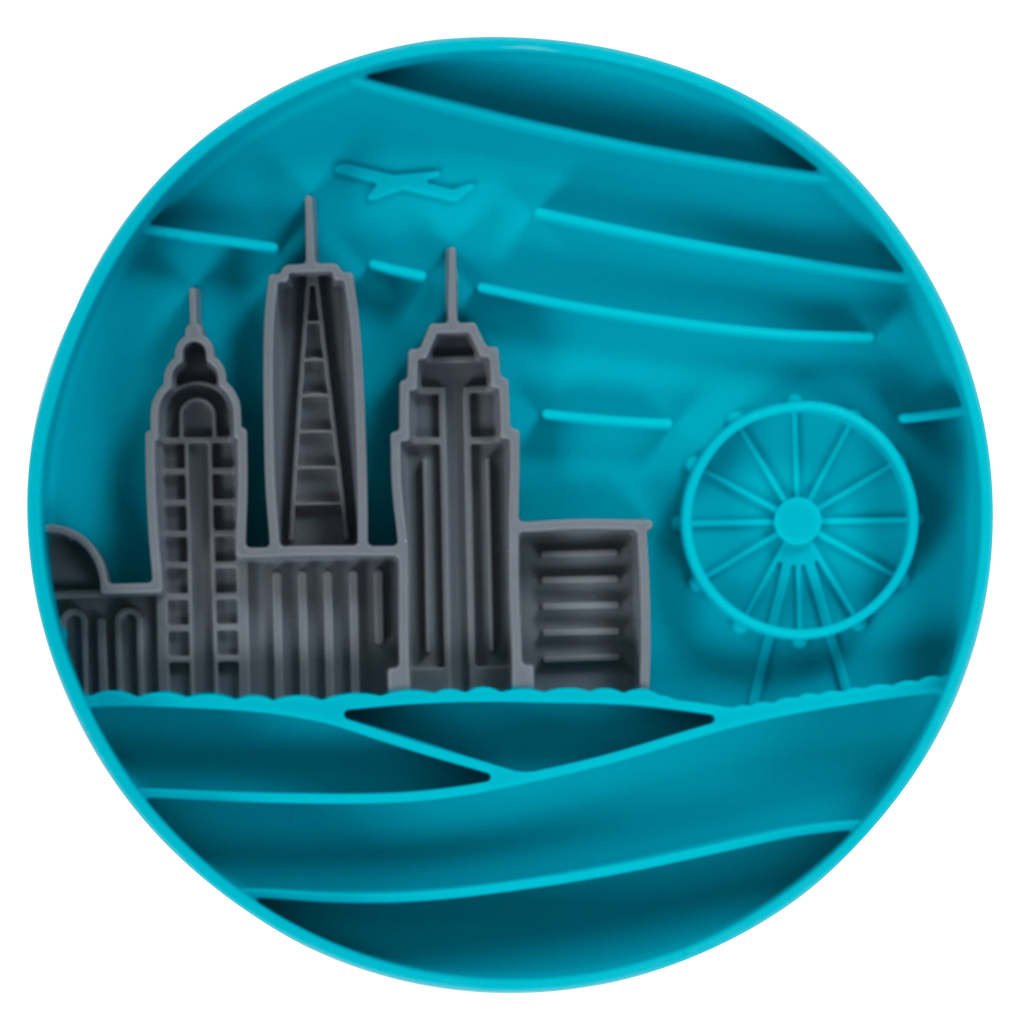 Blue silicone bowl with cityscape design with integrated suction cups to hold in place