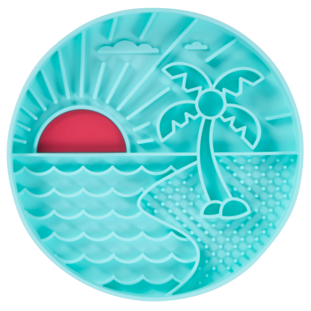Teal silicone dog slow feeder with beach scene design featuring a palm tree and sunset. Intergrated suction cups to hold bowl in place while eating.