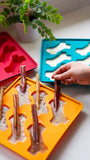dog popsicle molds with edible sticks.  Blue, red ,and orange available. Spill proof design. 