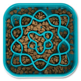 Blue interactive dog slow feeder with kibble between the barriers.  Slow down bowl.