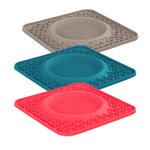 Dog Lick bowl mats in three colors.  Blue, Grey and Watermelon. The raised lick bowl holds up to 1 cup of liquid.